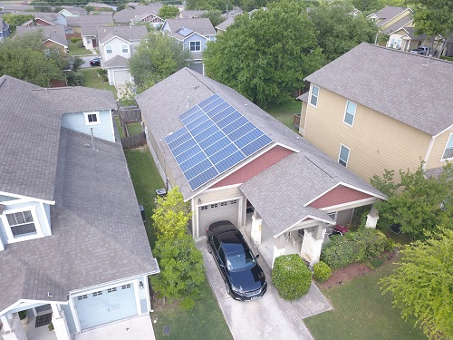 Aerial view of home with installed solar panels