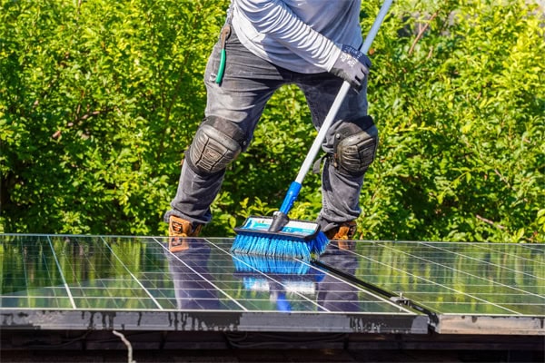 Worker Scrubbing Solar Panel – Longhorn Solar Worker Scrubbing Solar Panel - Longhorn Solar